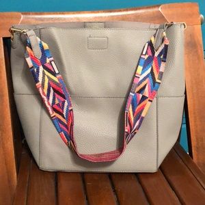 Grey leather bag with multicolor strap